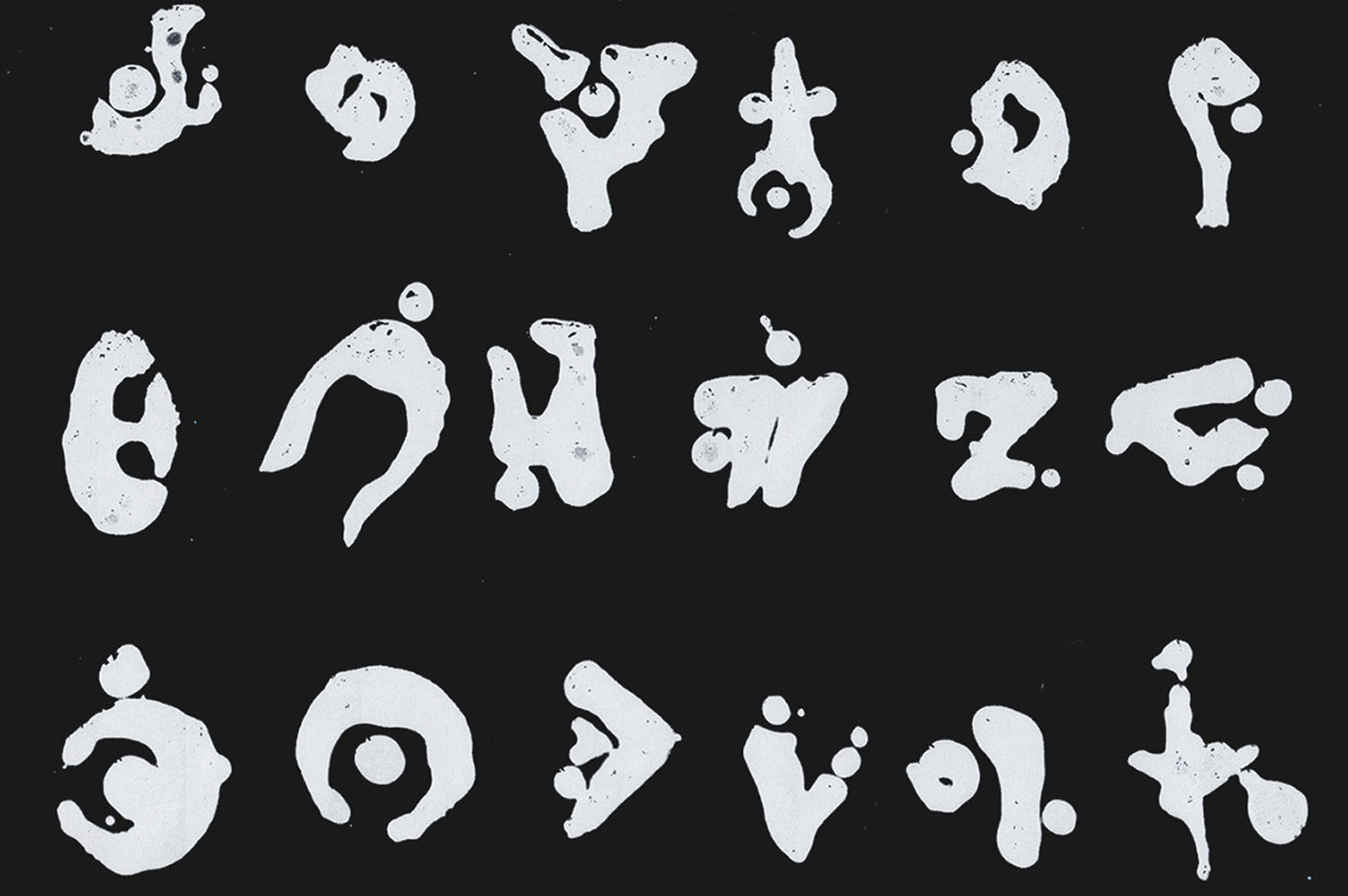 Outer World Glyphs experimental alphabet of abstract white symbols on a black background